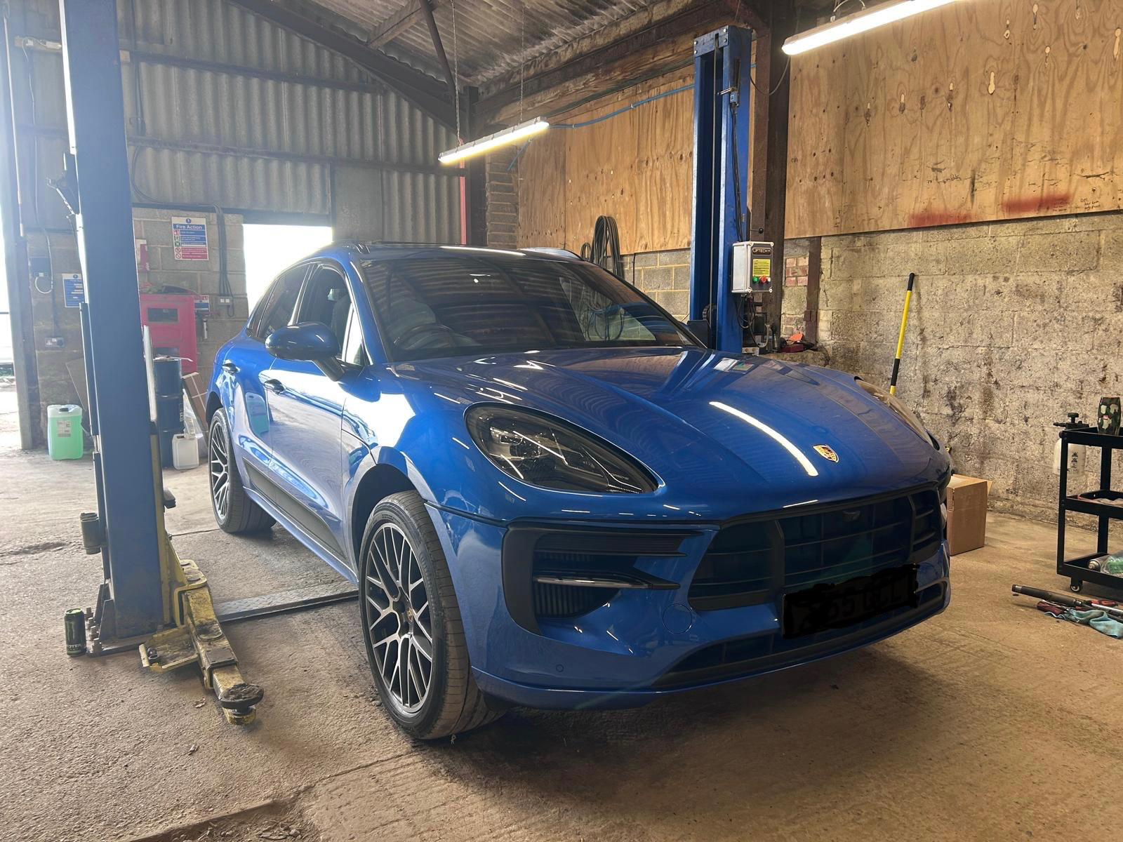 Blue Porsche Macan on the two-post lift at Southern VSR