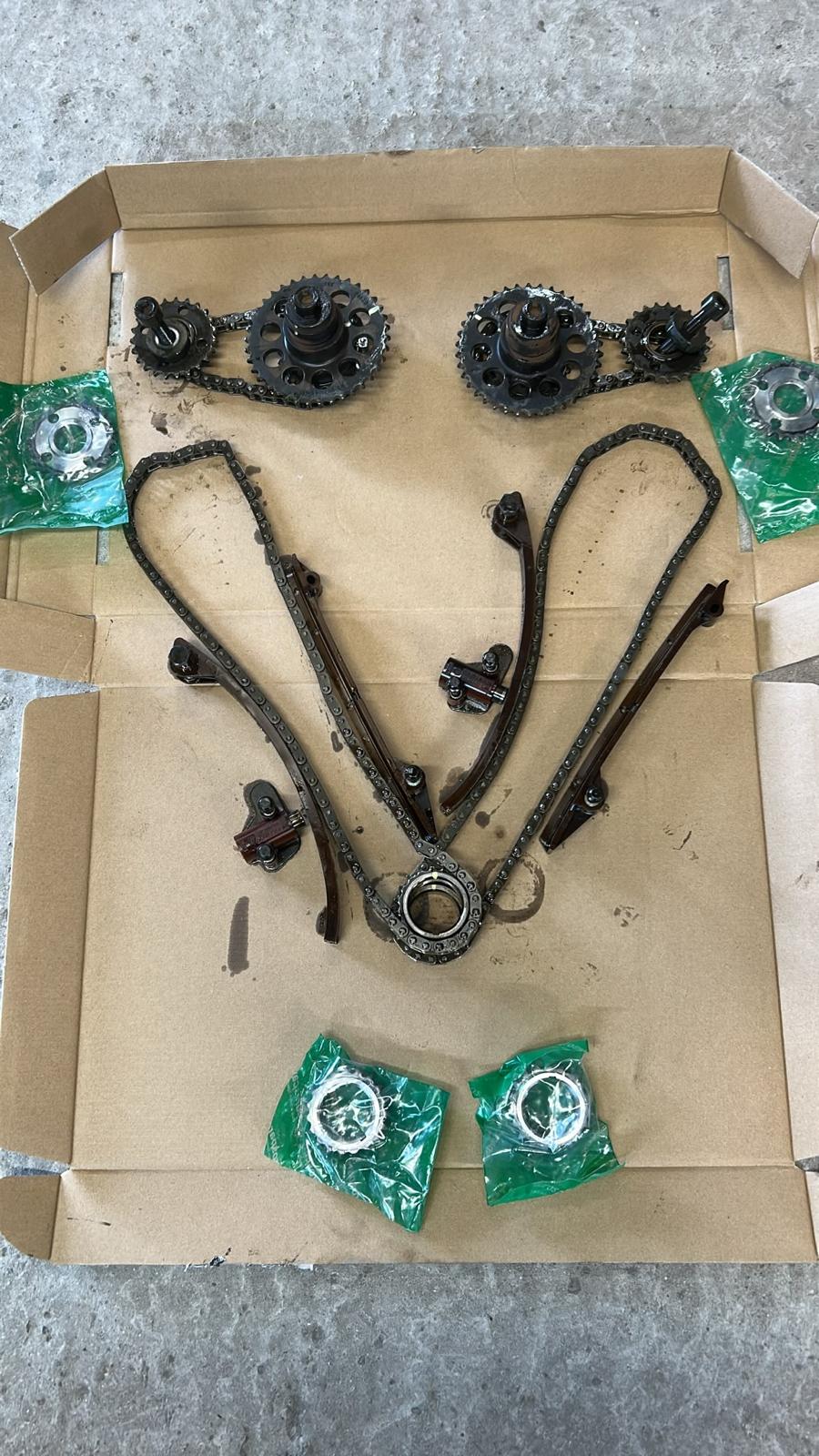 The complete set of removed chains, guides and tensioners