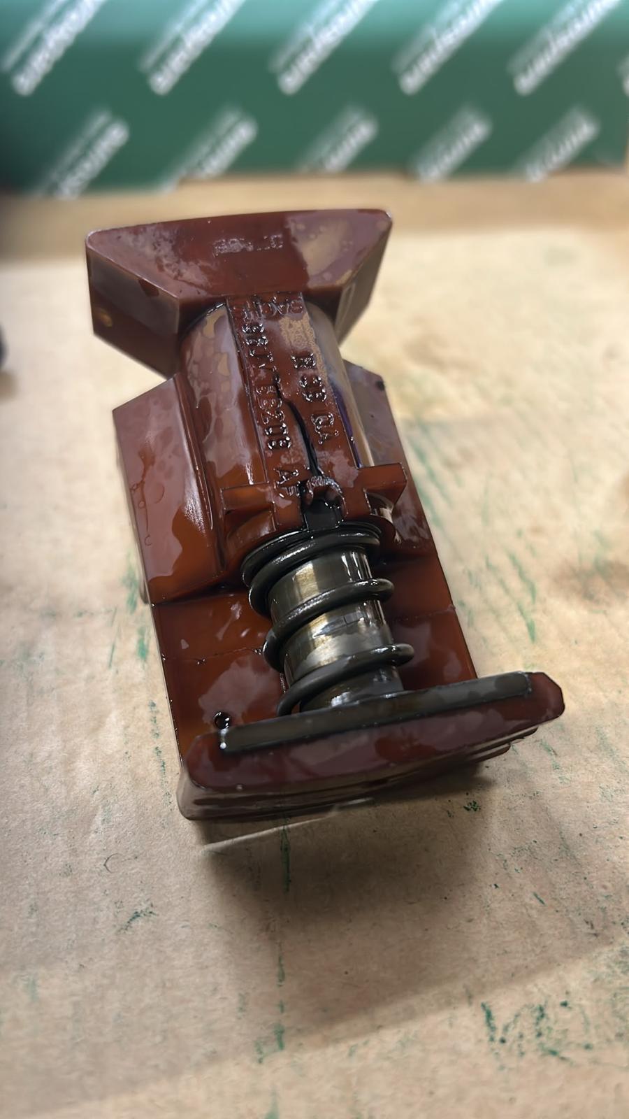 Worn timing chain tensioner removed from an engine during a timing chain replacement